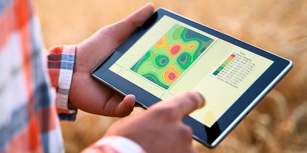 Tablet showing topographical style map indicating soil health across a field.
