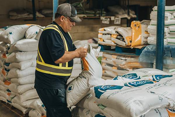 Co-op Embrun employee working in the feed warehouse.