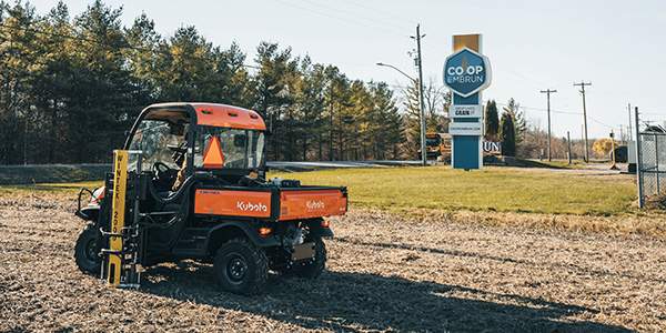 Kubota Side-by-side taking geo-referenced soil samples in a field next to the grain elevators. 