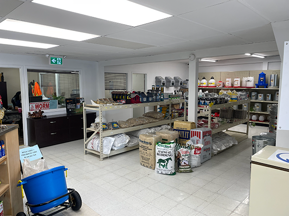 Interior photo of Embrun Co-op Copuntry DEpot store showing long handled farm tools, wheelbarrows, and pest control products.
