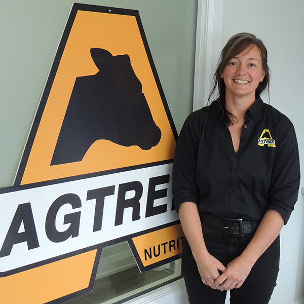 Jennifer Wubs standing next to her Co-op Embrun pick-up truck making farm visits.